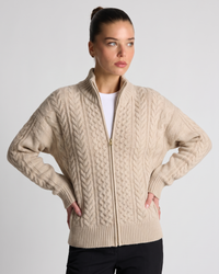 NOLA model wearing beige zip up cable knit cardigan