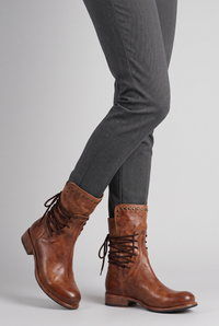 NOLA model wearing lace-up studded boots