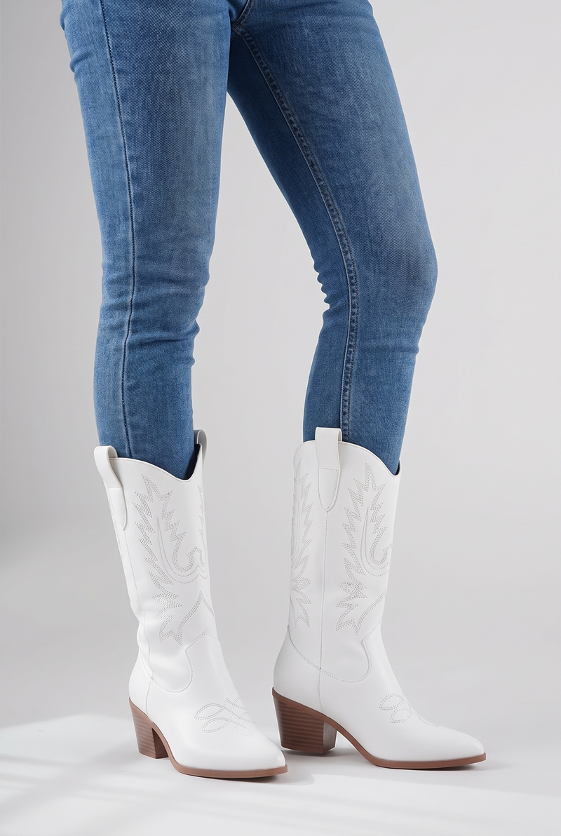 NOLA model wearing embroidered mid-calf cowboy boots black and white